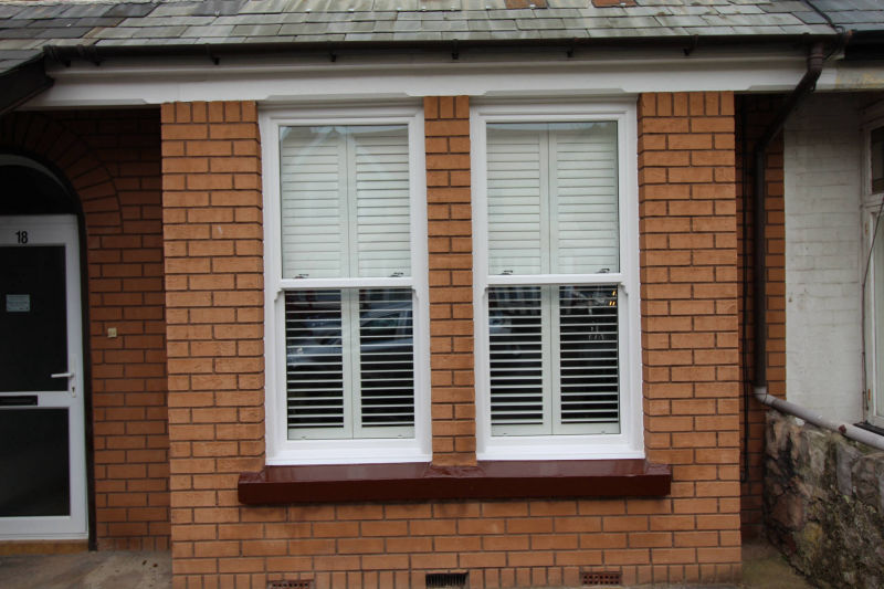 White wooden shutter, outside, half open